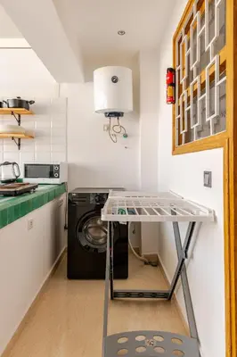 a table in a kitchen with a washing machine at New Luxurious apartment Agdal Rabat center in Rabat