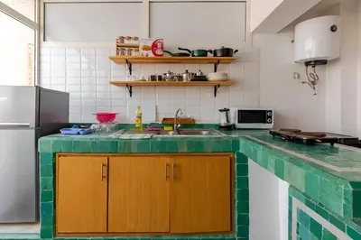 a kitchen with a green counter top at New Luxurious apartment Agdal Rabat center in Rabat