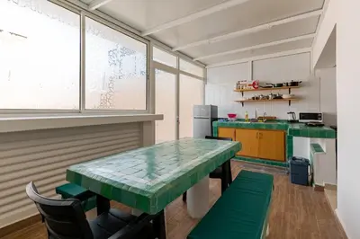 a kitchen with a table with a green counter top at New Luxurious apartment Agdal Rabat center in Rabat