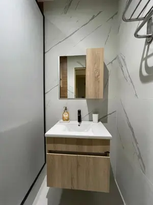a bathroom with a white sink and a mirror at Appartement Cosy Agdal Centre Rabat in Rabat
