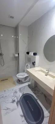 a white bathroom with a toilet and a sink at Eden Room SCH in Rabat