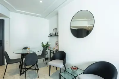 a room with a table and chairs and a mirror at Résidence Windsor in Casablanca