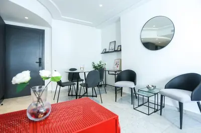 a living room with a red table and chairs at Résidence Windsor in Casablanca