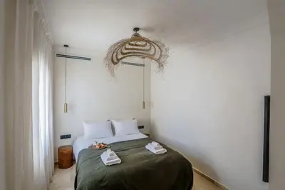 a bedroom with a bed with two towels on it at Résidence La Fontaine - Racine in Casablanca