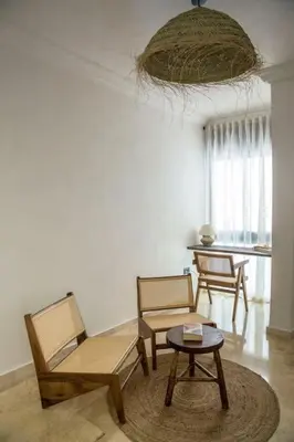 a living room with two chairs and a table at Résidence La Fontaine - Racine in Casablanca