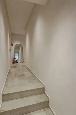 an empty hallway with stairs in a building at Résidence La Fontaine - Racine in Casablanca
