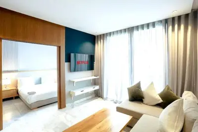 a living room with a couch and a bed and a mirror at Résidence B-Livin - La Ferme Bretonne in Casablanca