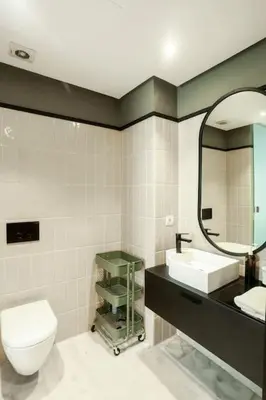 a bathroom with a toilet and a sink and a mirror at Résidence B-Livin - La Ferme Bretonne in Casablanca