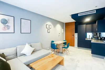 a living room with a couch and a table at Résidence B-Livin - La Ferme Bretonne in Casablanca