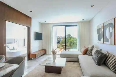 a living room with a couch and a table at Résidence B Livin - Oasis in Casablanca