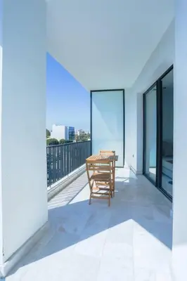 a table on the balcony of a house at Résidence B Livin - Oasis in Casablanca