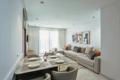 a living room with a table and a couch at Résidence B Livin - Oasis in Casablanca