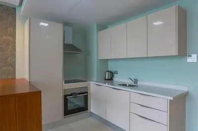 a kitchen with white cabinets and a sink at Résidence Anfa Sunset - Ain Diab Casablanca Beach in Casablanca