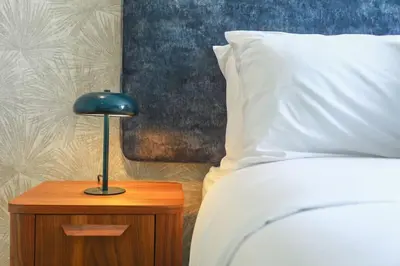 a blue lamp on a night stand next to a bed at Résidence Anfa Sunset - Ain Diab Casablanca Beach in Casablanca