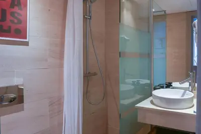 a bathroom with a sink and a glass shower at Résidence Anfa Sunset - Ain Diab Casablanca Beach in Casablanca