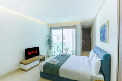 a bedroom with a bed and a tv in it at Résidence Ronomo - Racine in Casablanca