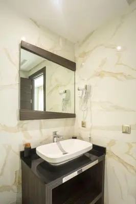 a bathroom with a sink and a mirror at Résidence Urban Square F26 in Casablanca