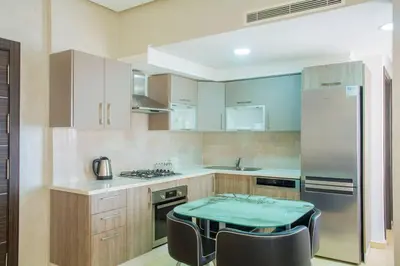 a kitchen with a table and chairs in it at Résidence Urban Square F26 in Casablanca