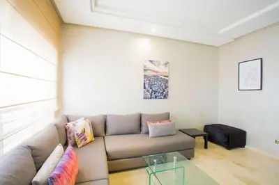 a living room with a couch and a glass table at Résidence Urban Square F26 in Casablanca
