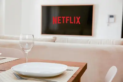 a table with a white plate and a wine glass at Résidence Urban Square D52 in Casablanca