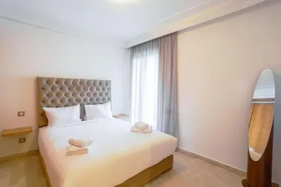 a bedroom with a bed with a surfboard in it at Résidence Smalto - Bd Anfa in Casablanca