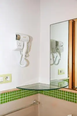 a mirror on the wall of a bathroom at Résidence Smalto - Bd Anfa in Casablanca