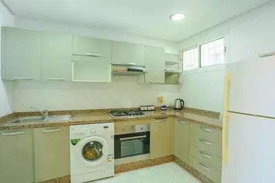 a kitchen with a washing machine and a washer at Résidence Bd Anfa in Casablanca