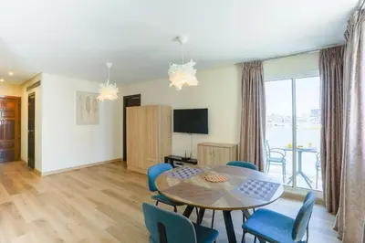 a dining room with a table and blue chairs at Résidence Bd Anfa in Casablanca