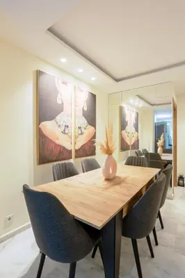 a dining room with a wooden table and chairs at Résidence Marie Césaire - Maarif in Casablanca