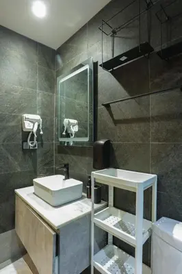 a bathroom with a sink and a mirror and a toilet at Résidence Marie Césaire - Maarif in Casablanca