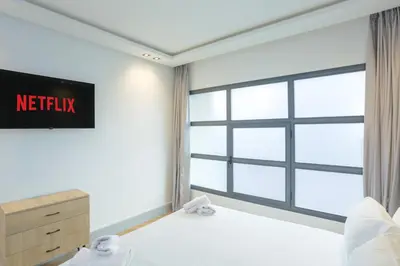 a bedroom with a netflix sign on the wall at Résidence Marie Césaire - Maarif in Casablanca