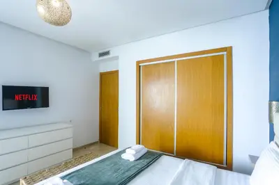a bedroom with a bed with a sliding door at Résidence Liberté in Casablanca