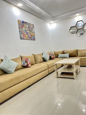a living room with a couch and a table at Appartement Moderne à OlaBlanca2 in Sidi Rahal