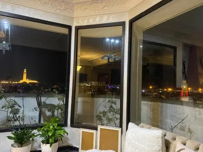 a room with windows with a view of a city at اقامة الهام in Casablanca