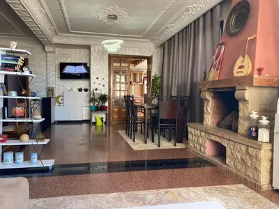 a living room with a fireplace and a dining room at اقامة الهام in Casablanca