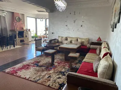 a living room with a couch and a table at اقامة الهام in Casablanca
