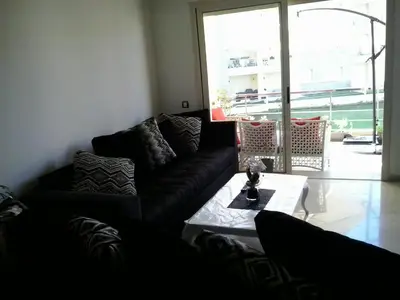 a living room with a couch and a coffee table at Appartement Bella Vista in Bouznika