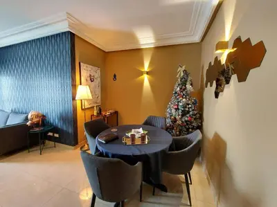 a christmas tree in a room with a table and chairs at Appartement chic avec Terrasse in Casablanca