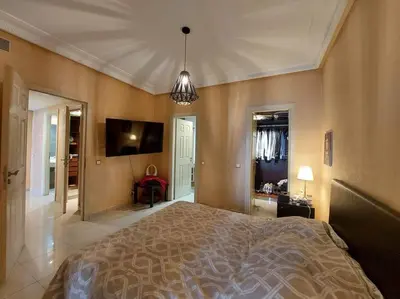 a bedroom with a large bed and a flat screen tv at Appartement chic avec Terrasse in Casablanca
