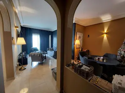 a living room with a couch and a table in a room at Appartement chic avec Terrasse in Casablanca