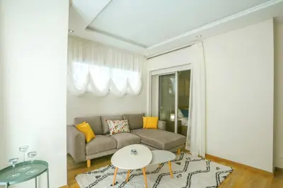 a living room with a couch and a table at Résidence Doribel in Casablanca