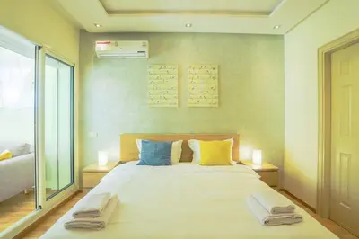 a bedroom with a large bed with towels on it at Résidence Doribel in Casablanca