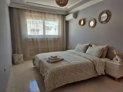 a bedroom with a bed with two towels on it at My Cosy Place Rabat - Cosy Apartement Avenue de France in Rabat