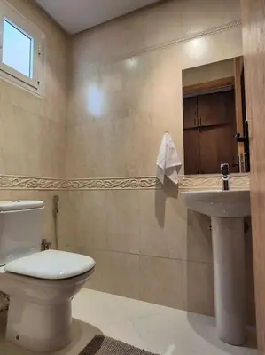 a bathroom with a toilet and a sink at My Cosy Place Rabat - Cosy Apartement Avenue de France in Rabat