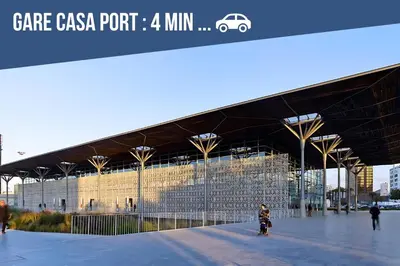 a large building with people standing in front of it at Studio Cosy Proche Gares & Mosqué Hassan II in Casablanca