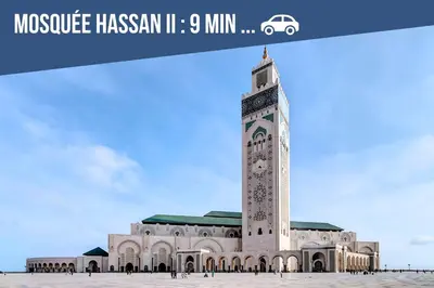 a mosque with a clock tower in front of it at Studio Cosy Proche Gares & Mosqué Hassan II in Casablanca