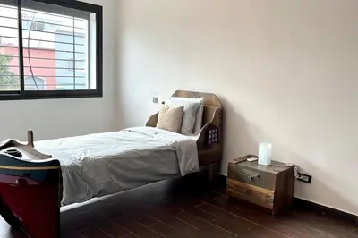a bedroom with a bed and a window and a table at Luxury villa with private pool in Casablanca