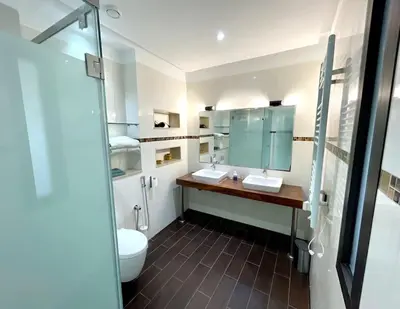 a bathroom with two sinks and a toilet at Luxury villa with private pool in Casablanca