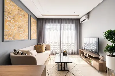 a living room with a couch and a tv at The Twenty-Six Palmier by IB Signature - Design 1Bedroom Apt with Wifi, Parking, Self check-in, 24 x7 Security - City View with terrace - Walk to Cafes! City Centre, Tram in Casablanca