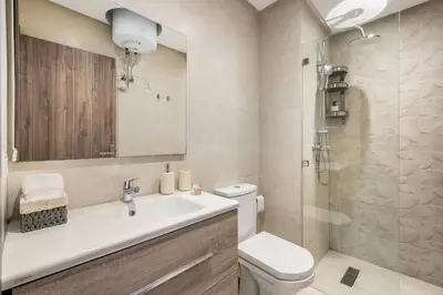 a bathroom with a sink and a toilet and a shower at The Twenty-Six Palmier by IB Signature - Design 1Bedroom Apt with Wifi, Parking, Self check-in, 24 x7 Security - City View with terrace - Walk to Cafes! City Centre, Tram in Casablanca